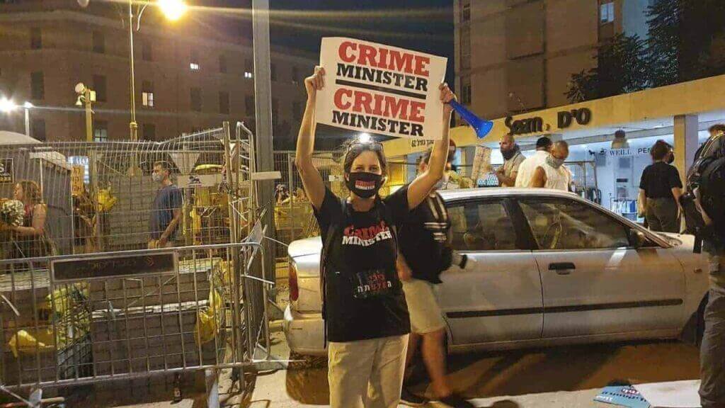They’re not even people. Plan to push palestinians into rafah. A protester holds a sign that says crime minister during 2020 protests against netanyahu.