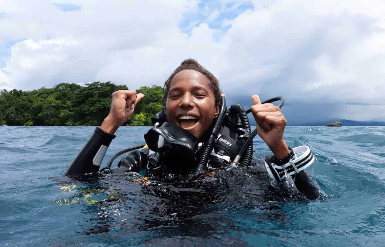 img 4699 Conservationist naomi longa a man in scuba gear coming up in the water smiling and cheering