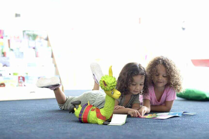 img 5502 Environmental activities for kids children lying on the floor reading a book together