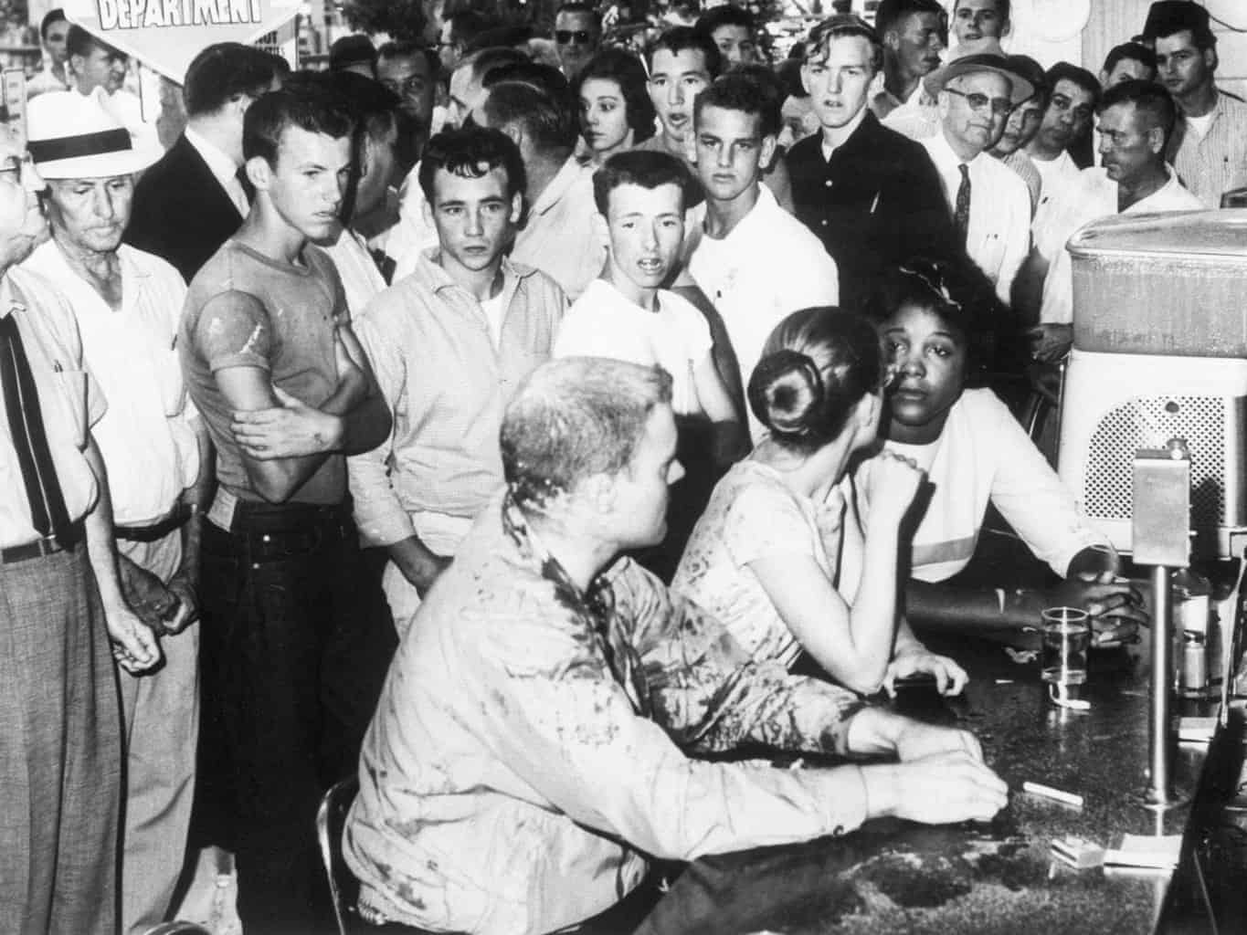 Black women being intimidated by white men in a “white’s only” restaurant.