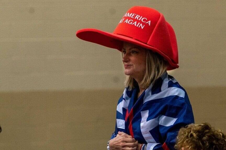Maga woman wearing an oversized red maga hat in florid