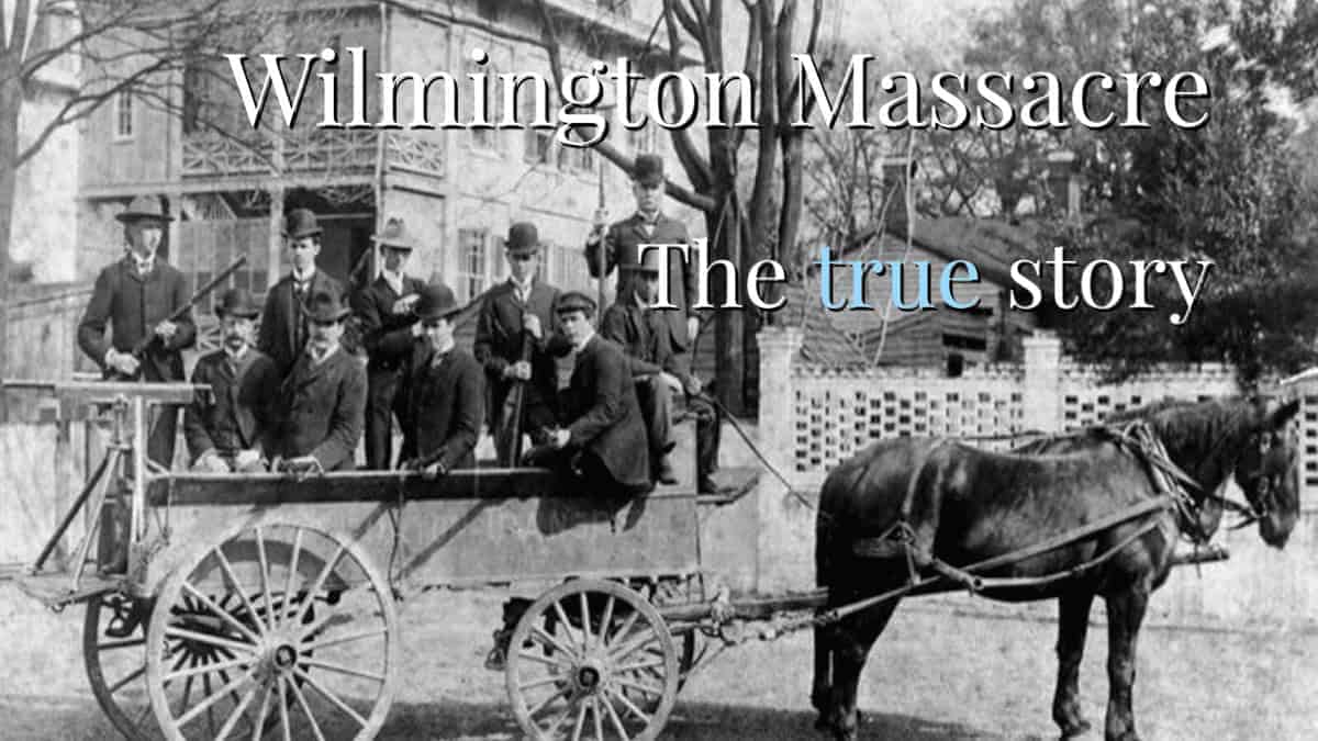 Black and white photo of white men in a horse drawn wagon with guns in 1898