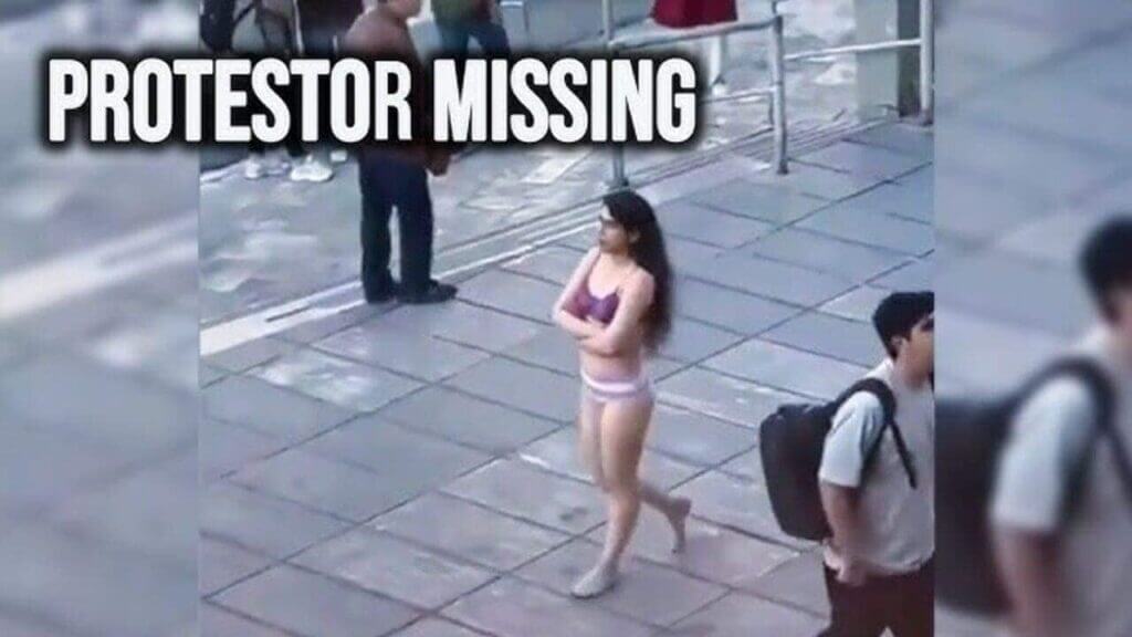 Woman walking down the street in her bra and underwear in protest in iran