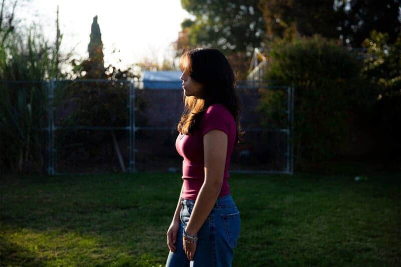 teen standing outside Climate change is affecting teens mental health a teen girl stands outside