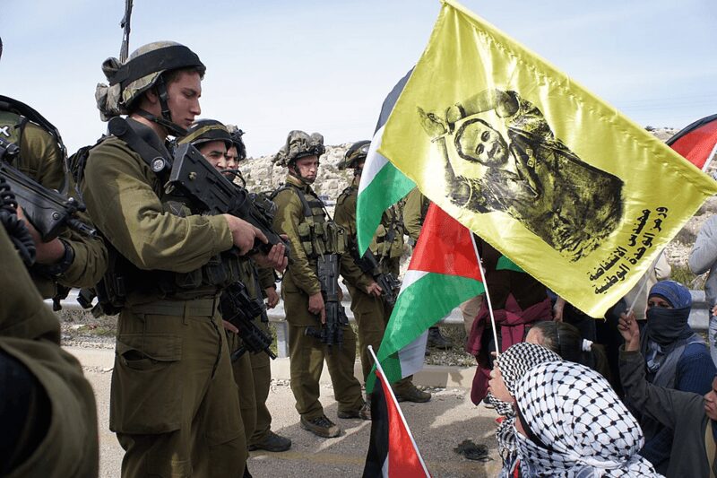 protest agsinst israeli land theft Palestinians protesting against israeli land theft. The marwan barghouti flag is in the crowd.