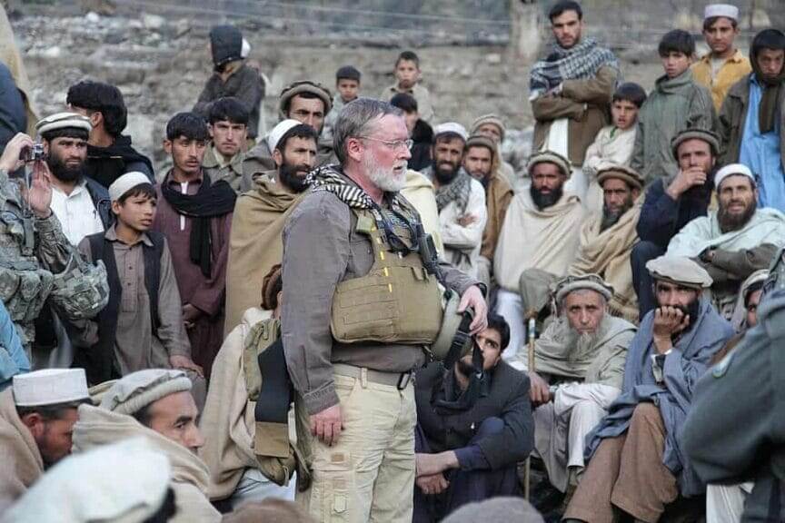 Federal aid worker speaking to aghan citizens. Ban on humanitarian aid