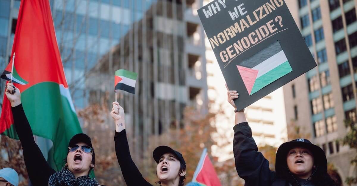 pexels photo 19544033 19544033 Belonging a protest scene with palestinian flags and banners advocating for peace and against genocide.