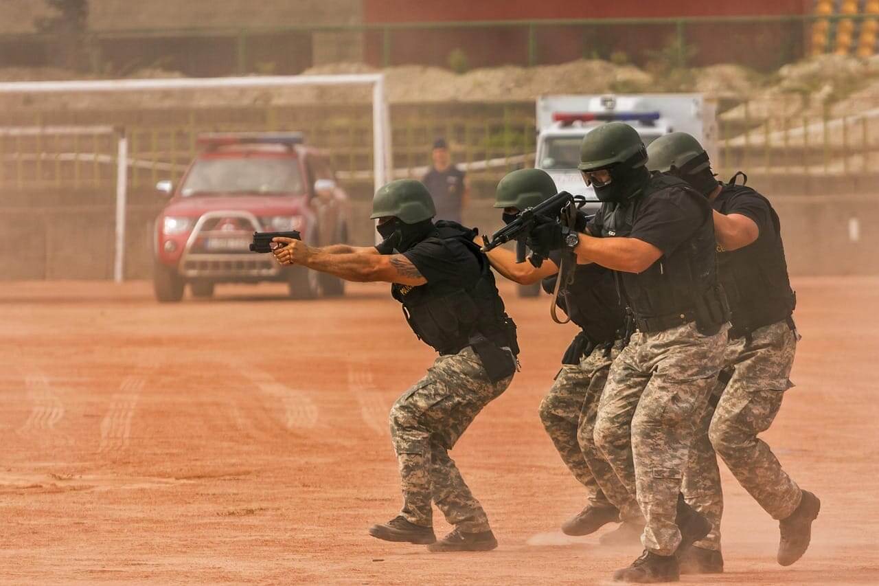 Deadly conduct violations by police. Officers in a raid stance during training with weapons drawn
