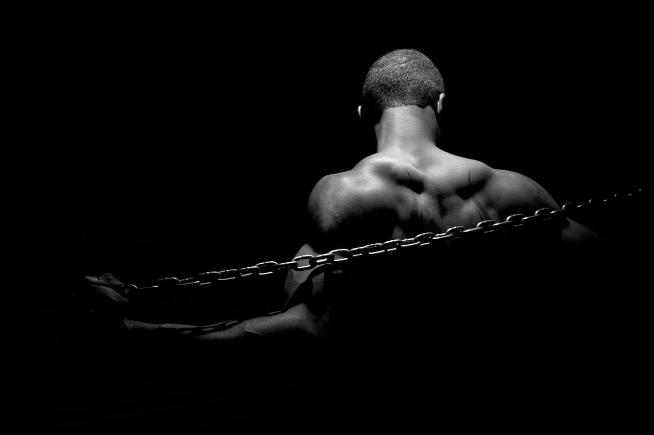 Black man in chains, black background, black and white photo
president’s house slavery exhibit
