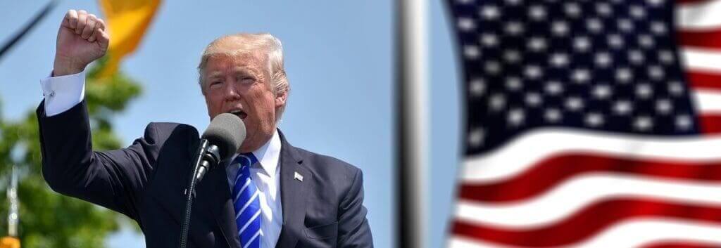 authoritarian leader Authoritarian donald trump raising a fist while shouting into a microphone. The american flag flies beside him.