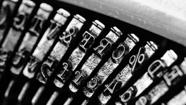 George orwell was opposed to totalitarianism. Metal letters inside a typewriter close up and in black and white