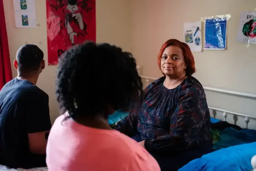 mother with children Mother sitting in the bedroom with teen kids