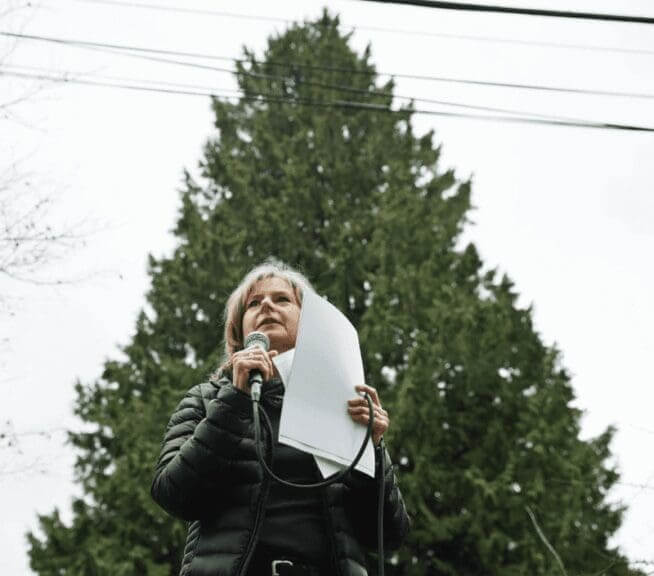 tree protection speaker Woman speaking at outdoor tree protection event