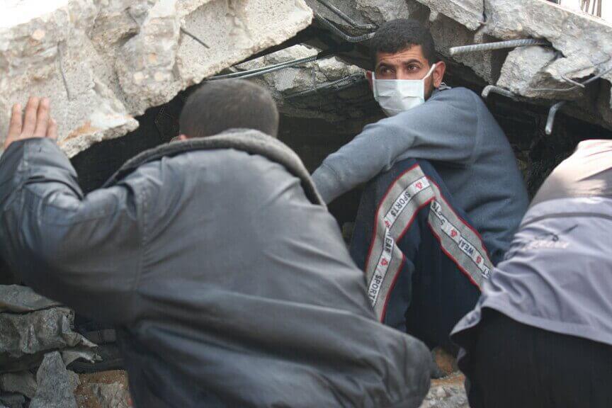 Workers dig through rubble in search of bodies of the missing in gaza
