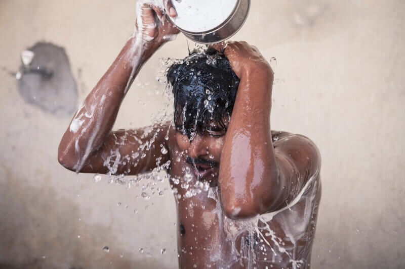 man in shower Migrant worker showering in nepal