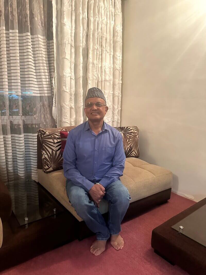 man posing on couch Man posing and smiling on a couch