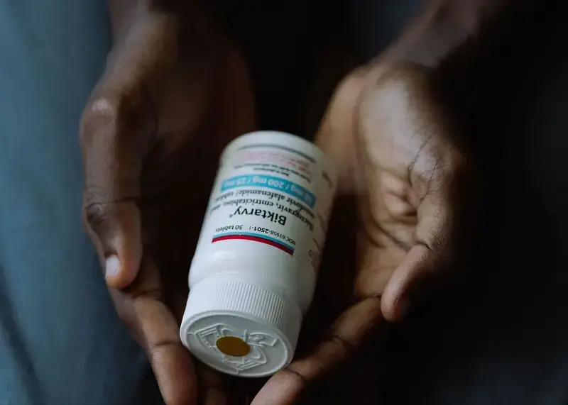 hiv medication Man holding a bottle of hiv medication