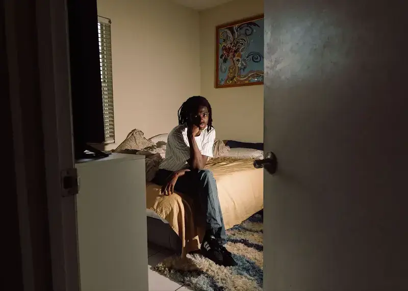 man sitting on bed Man sitting on a bed
