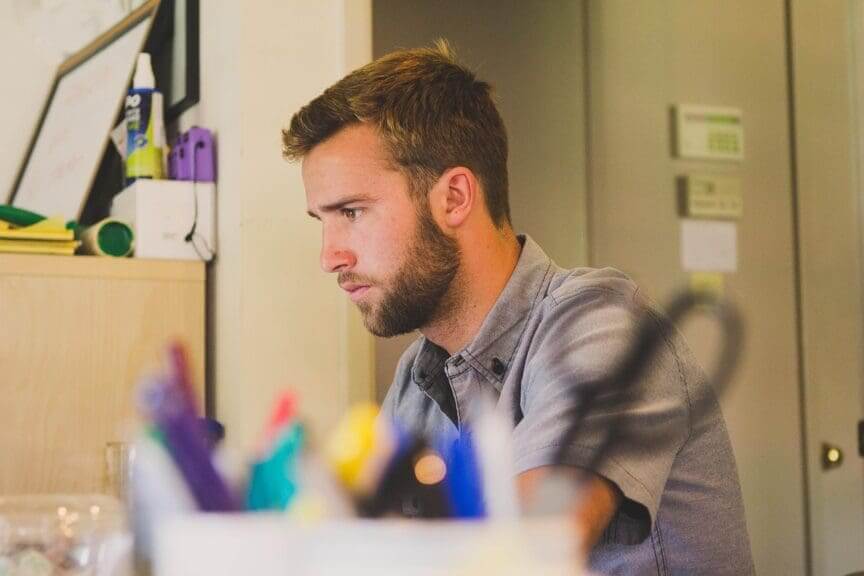 Man working at a desk in an office ai won't replace