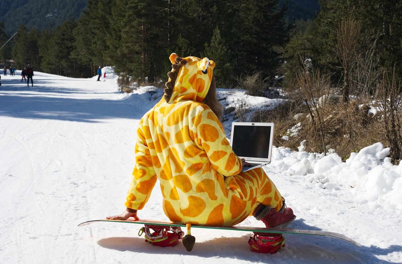 giraffe snowboarder Write for us image of a woman dressed up as a giraffe on a snowboard