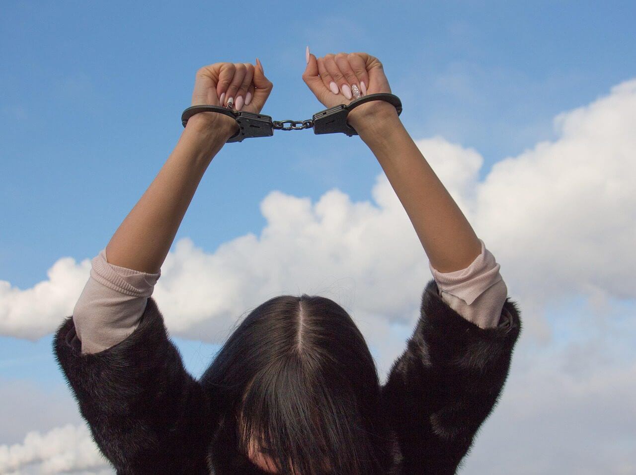 Civil rights violations woman in handcuffs. Abortion is homicide