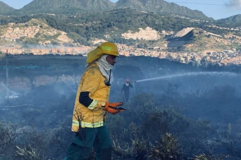 firefighter latin america Firefighter in colombia fighting a forest fire