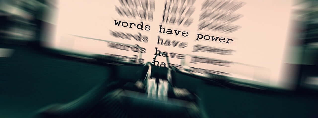Typewriter and paper with the power of words typed on it