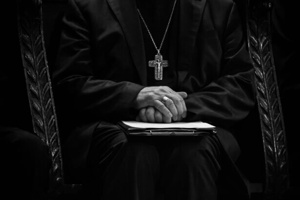 Catholic priests wearing cross necklace in black and white