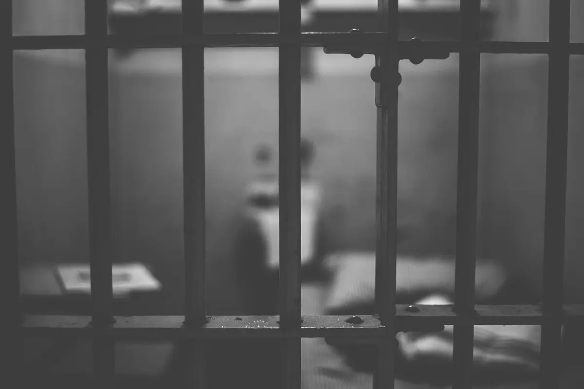 prison cell bars blurred bg Death penalty. Prison cell door close-up