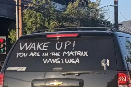 Qanon writing about deep state on rear window of an suv