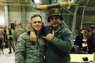 taylor rehmet veterans affairs Taylor rehmet in his military uniform posing with another service member.