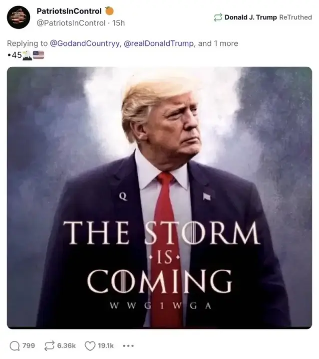 trump q pin Social media post screenshot of trump wearing a q lapel pin