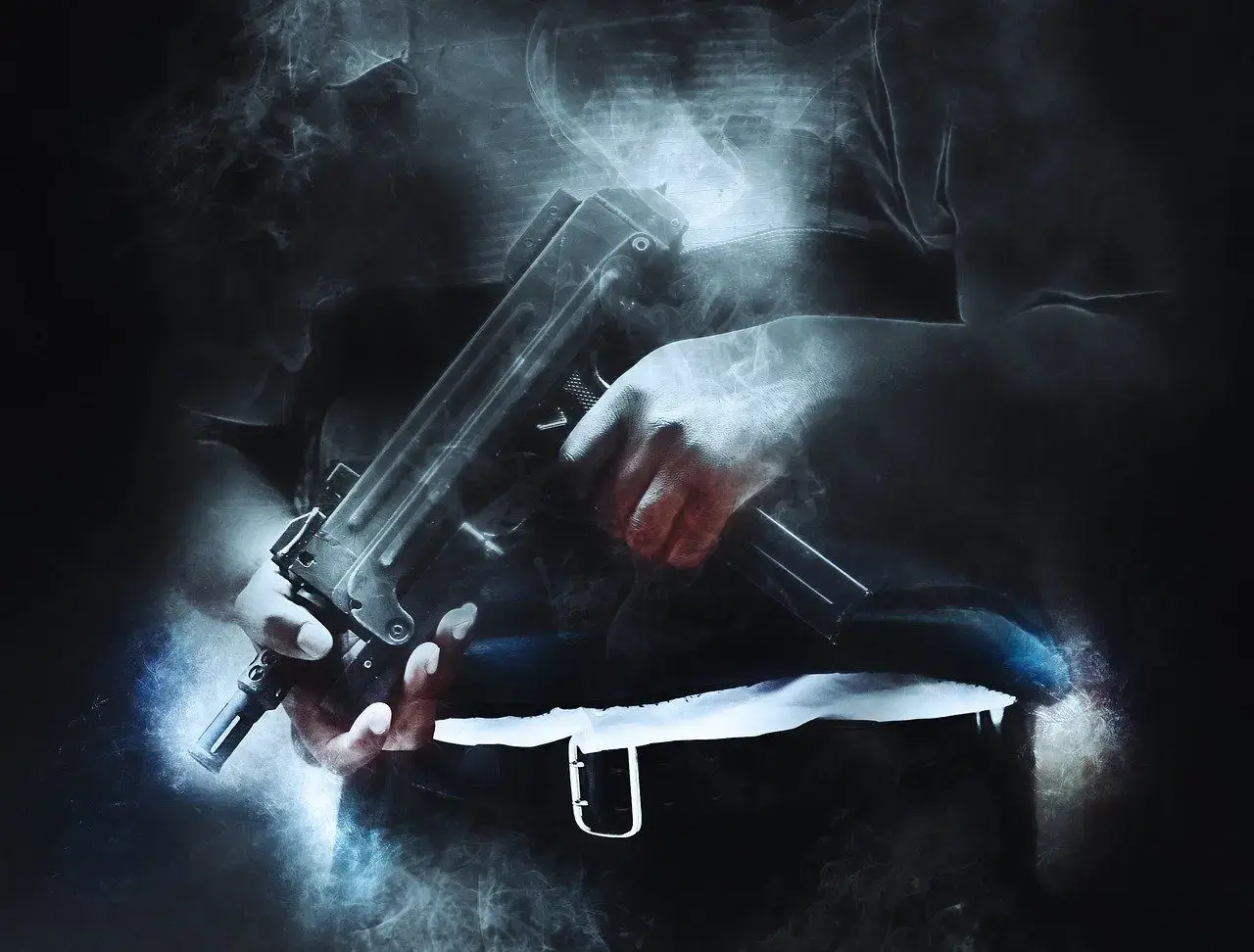 Black and white image of a man holding a gun