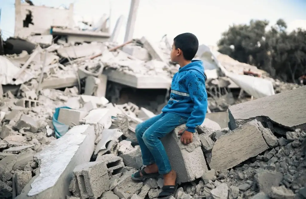 boy in gaza rubble Boy sitting on rubble in gaza. Peace plan for gaza