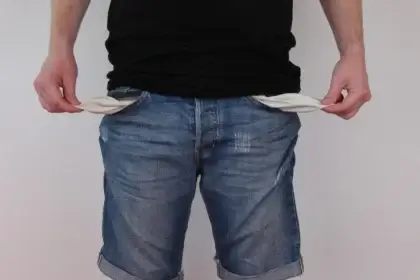 2027 budget cuts benefits to fund war. A man showing empty pockets