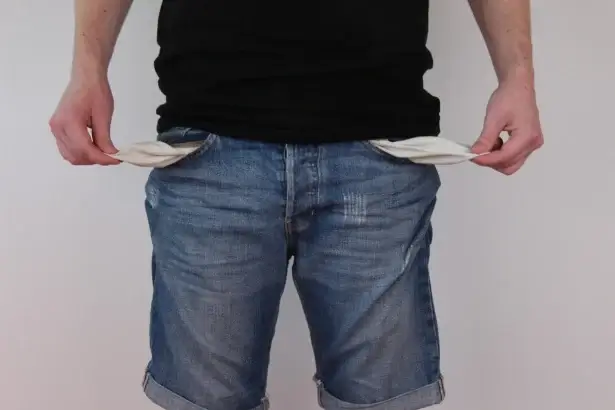 2027 budget cuts benefits to fund war. A man showing empty pockets