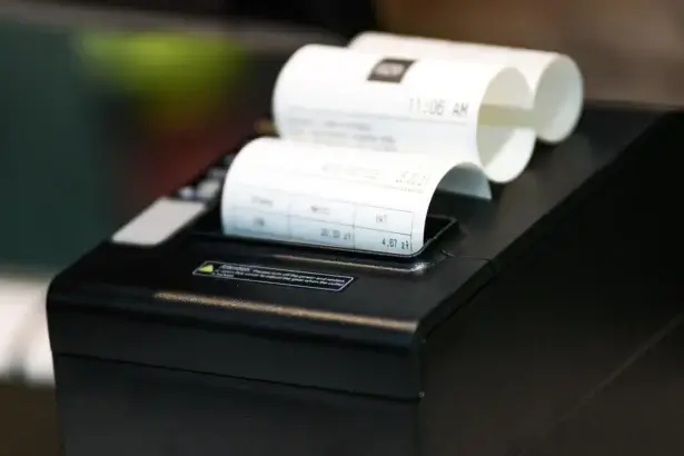 A cash register printer printing a receipt