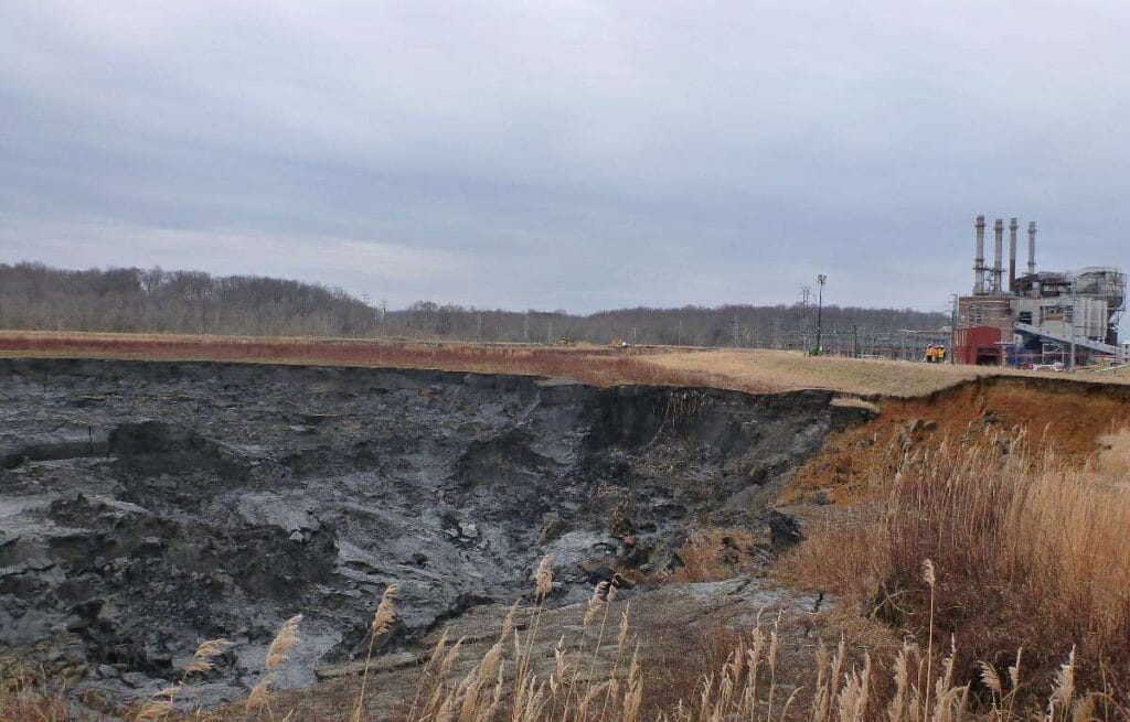 View of collapsed coal ash impoundment and closed power plant at dan river steam station (duke energy), eden, north carolina. The impoundment failure caused the 2014 dan river coal ash spill.