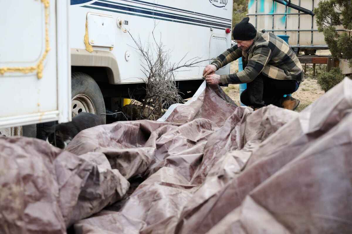 deschutes encampment Man who lived in the deschutes national forest encampment working on a trailer