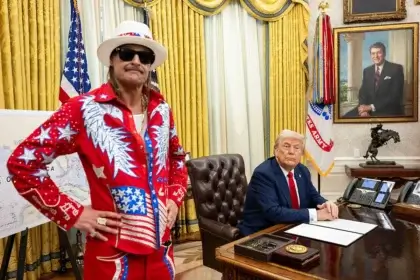 President donald trump signs an executive order alongside kid rock in the oval office, monday, march 31, 2025. (official white house photo by molly riley)