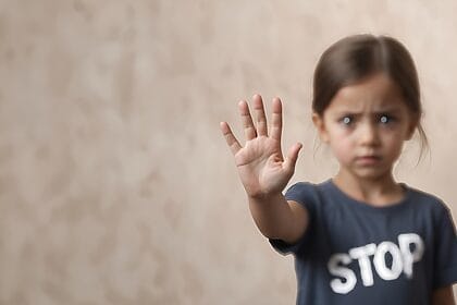 Little girl wearing a t-shirt that says stop, hold up a hand to say stop pro-israel groups critics of israel