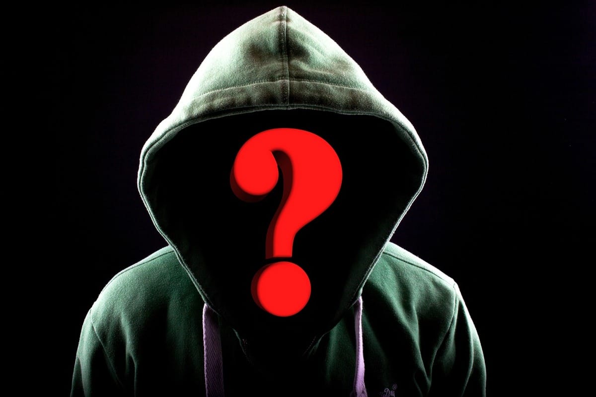 Person in a hoodie with a red question mark hiding their face. Stop the harassment