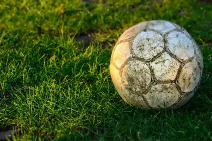 Fifa world cup disaster. A muddy soccer ball in the grass