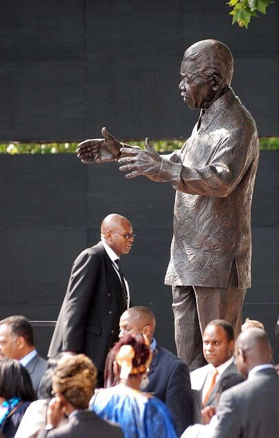 Bronze statue of nelson mandela. White south african refugees get a fake version of his history