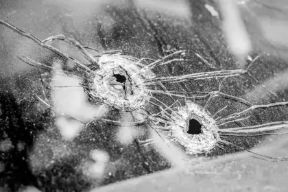 Police shot 1-year-old in car at walmart. Photo of car window with two bullet holes in it